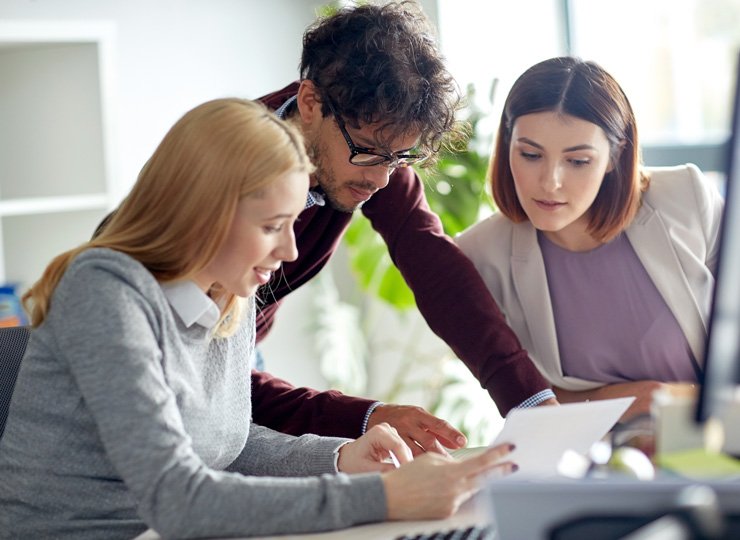 Team of professionals collaborating on a business project in a modern office